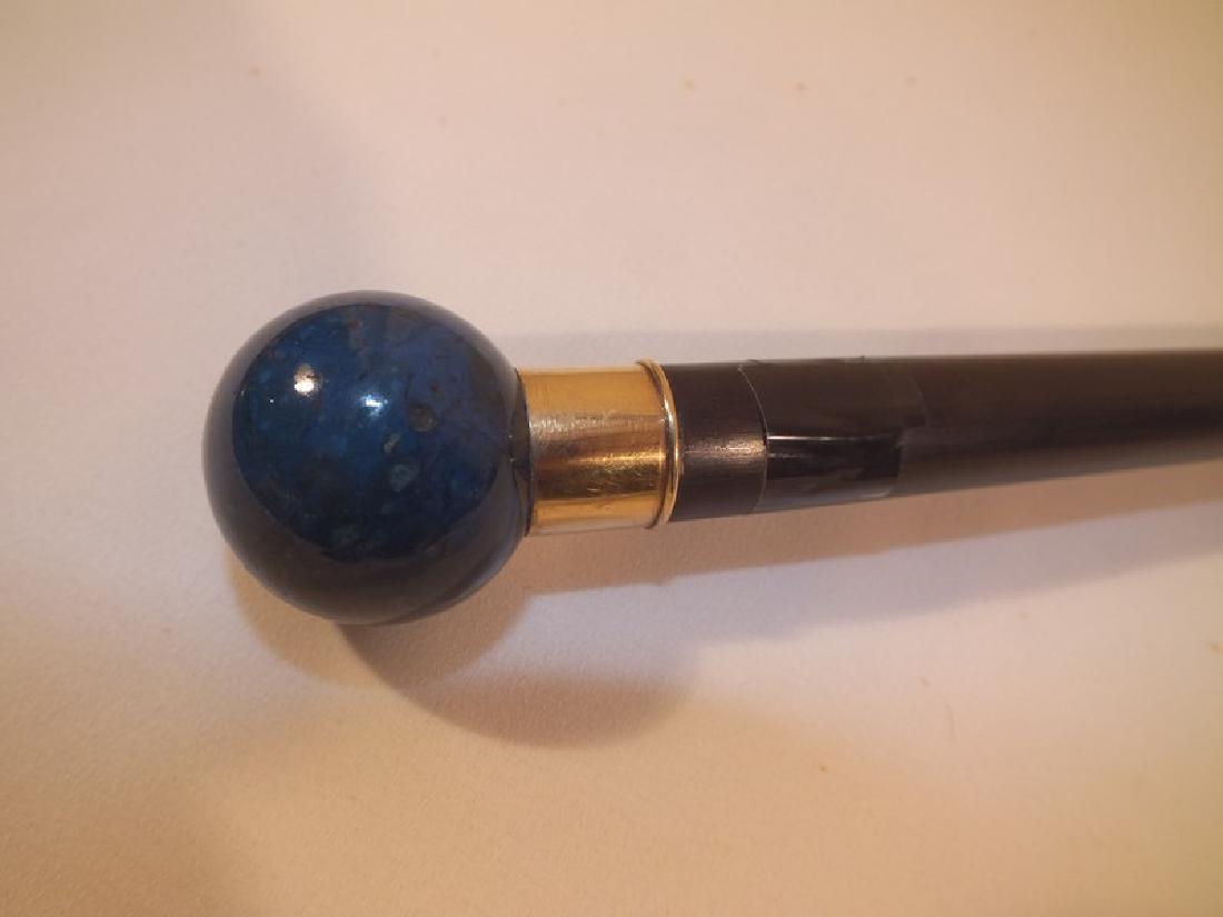 ANTIQUE LAPIS & GOLD CANE: Antique polished lapis lazuli knob cane with gold collar and ebony shaft, 36 inches long, knob is 1.25 in diameter.