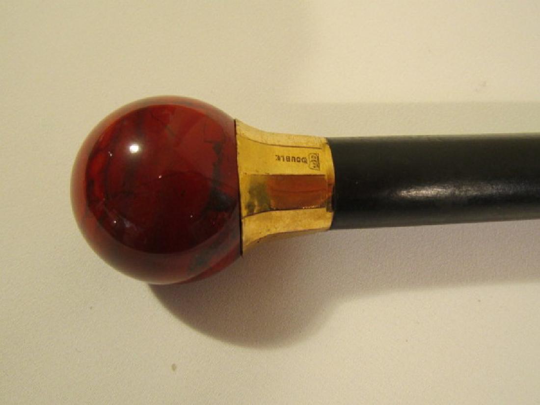 ANTIQUE RED AGATE KNOB CANE: Red agate 2 inch knob cane with gold filled collar stamped TD Double, ebony shaft, 36.5 inches long.