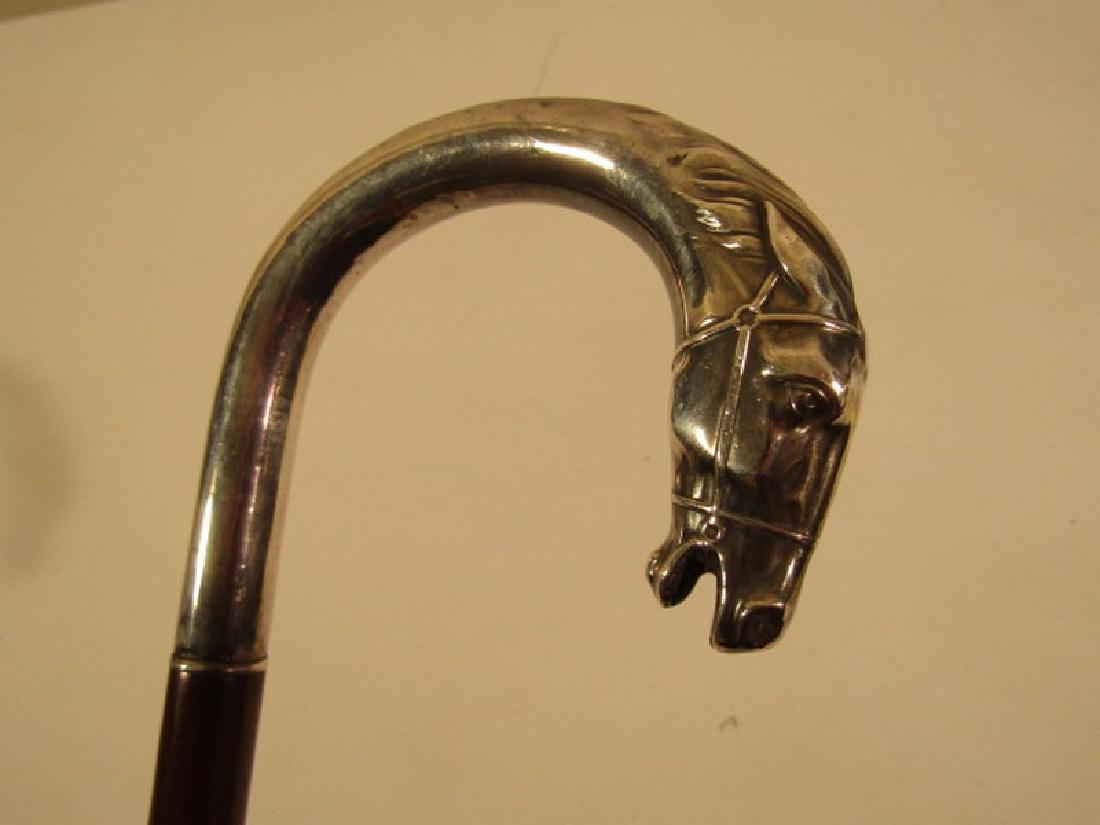 ANTIQUE SILVER HORSE HEAD CANE: Sterling silver horse head curved handle cane with wood shaft and antler ferrule, hallmarked. 36 inches long.