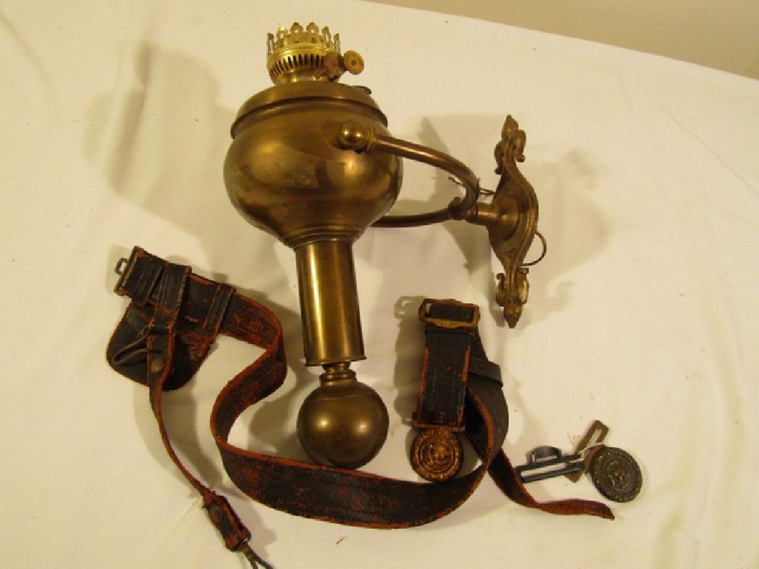 LOT: SHIPS GIMBAL LAMP & US BELTS: Old Scottish brass ship's gimbal oil lamp signed C. Gray, 16 in high together with old military eagle belt buckle and eagle ammunition belt plus 2 Civil War mini balls 58 caliber.
