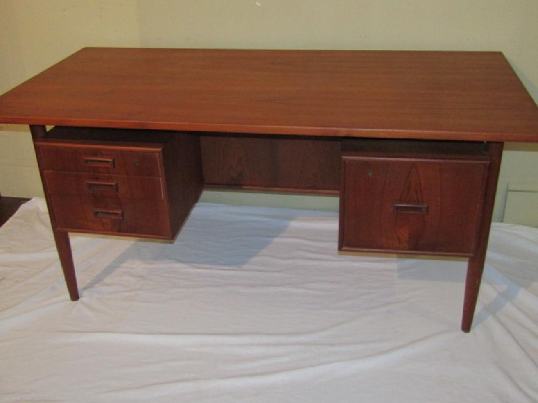 DANISH MODERN FLOATING TOP DESK: Vintage Danish modern teakwood 4 drawer "floating top" executive desk signed Staedtler Germany. Top is 63 x 31 inches, 30 in high.