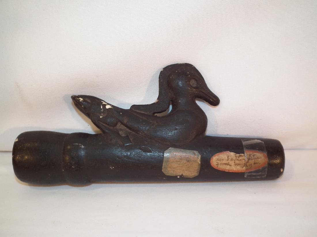 NATIVE AMERICAN CLAY PIPE WITH BIRD: Antique Native American black clay pipe with figure of a duck or water bird. Old paper labels. 9.25 x 4.25 inches high.