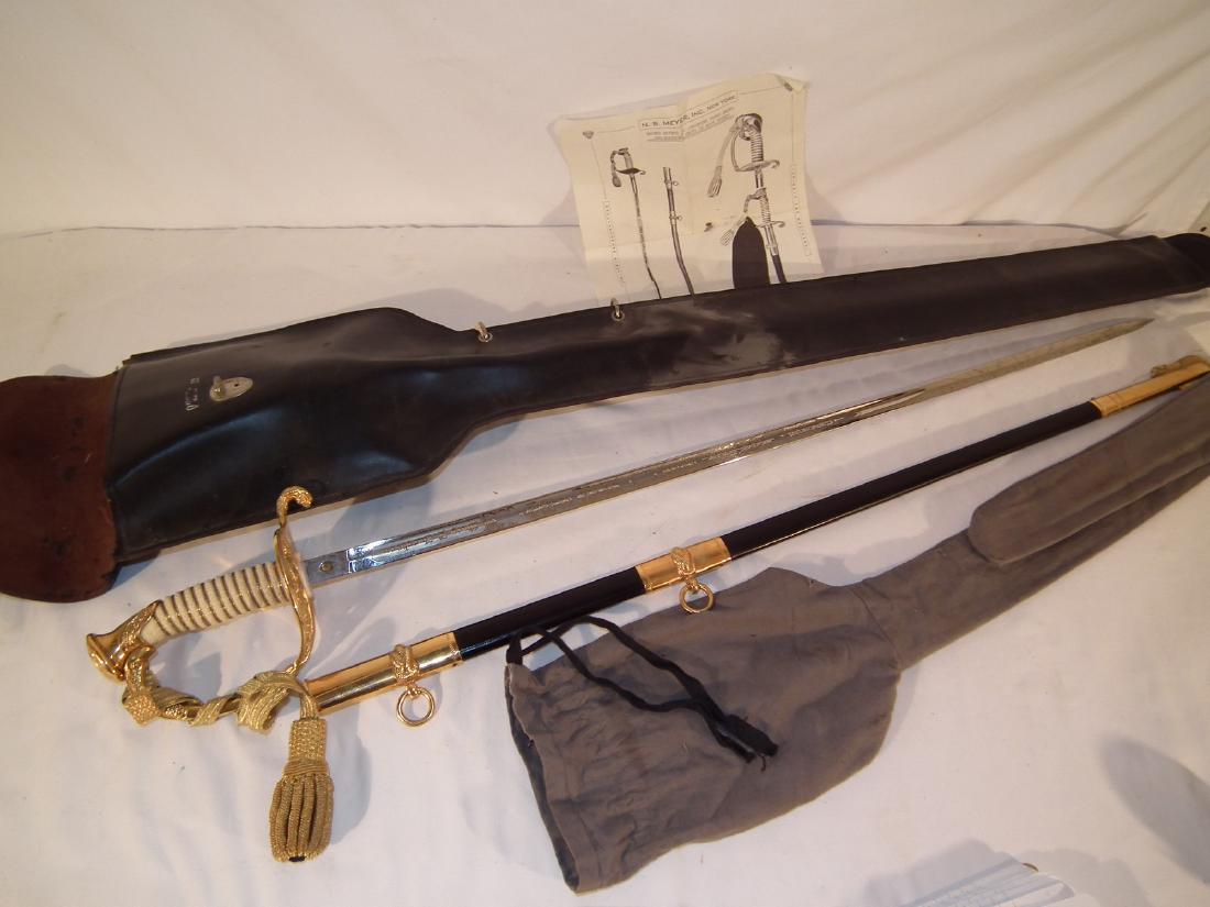 US NAVAL ACADEMY SWORD - MEYER: US Naval Academy gilt cadet sword signd NS Meyer in mint condition, complete with leather case, felt bag, scabbard, sword knot, belt and instructions. Blade engraved with owner name GARY B. JACOBSEN, 