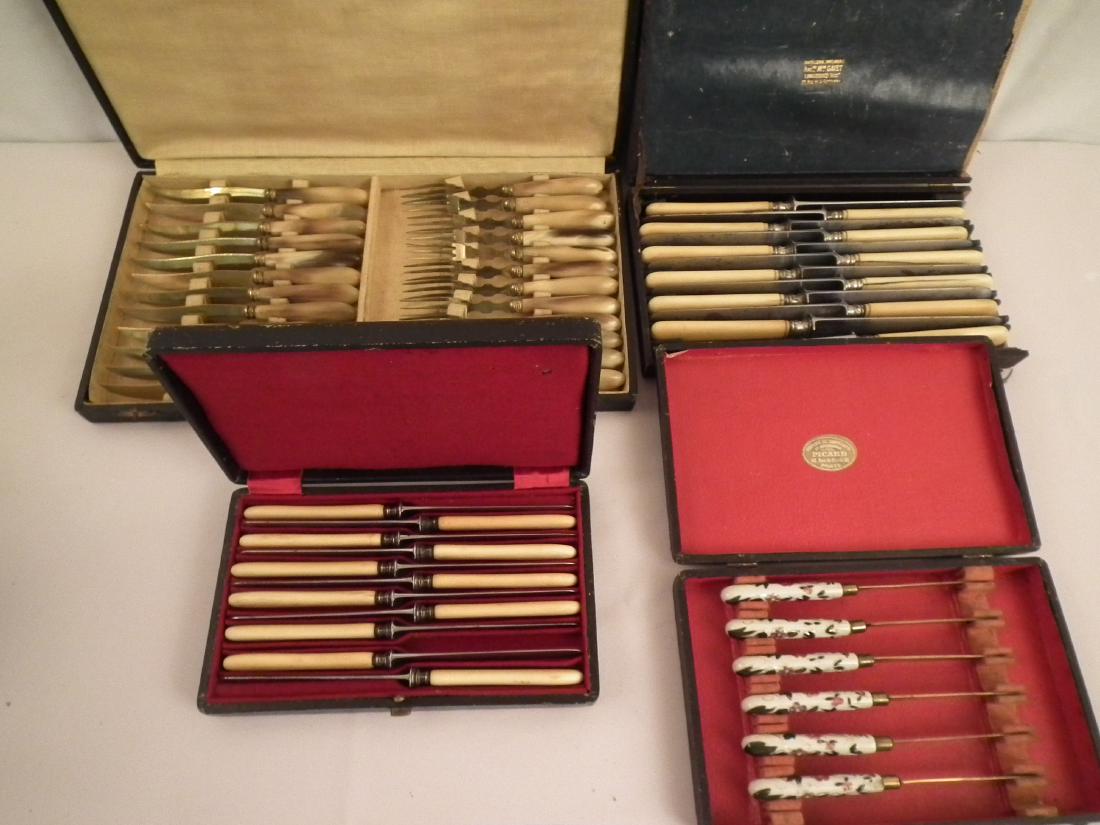 4 SETS FLATWARE CASED: 4 sets of old French cased flatware including: 6 porcelain fruit knives; 11 French bone handled butter knives; 12 bone handled French 10 in knives (cracks, case damage); 24 piece gilt frut set with an