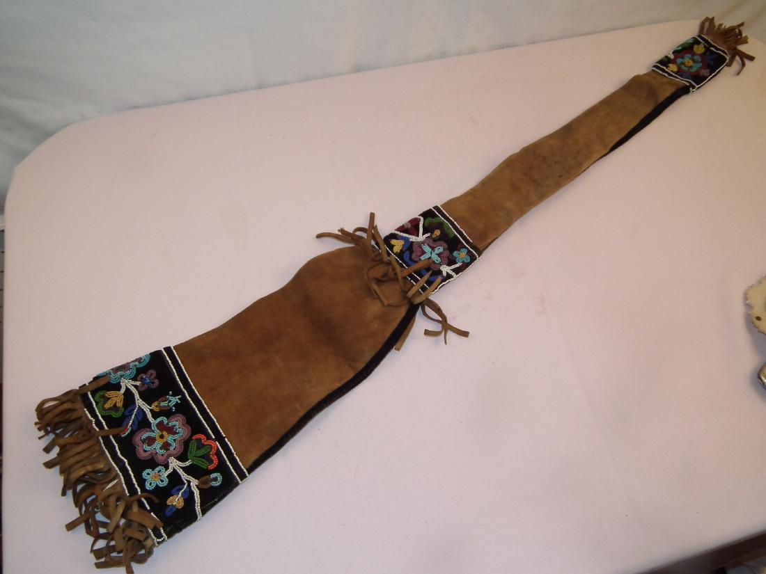 WOODLAND INDIAN BEADED RIFLE BAG: Antique Native American Woodland Indian (Cree) suede rifle bag with beaded floral designs attr. Sioux. 43 in long x 8 in wide. Good condition