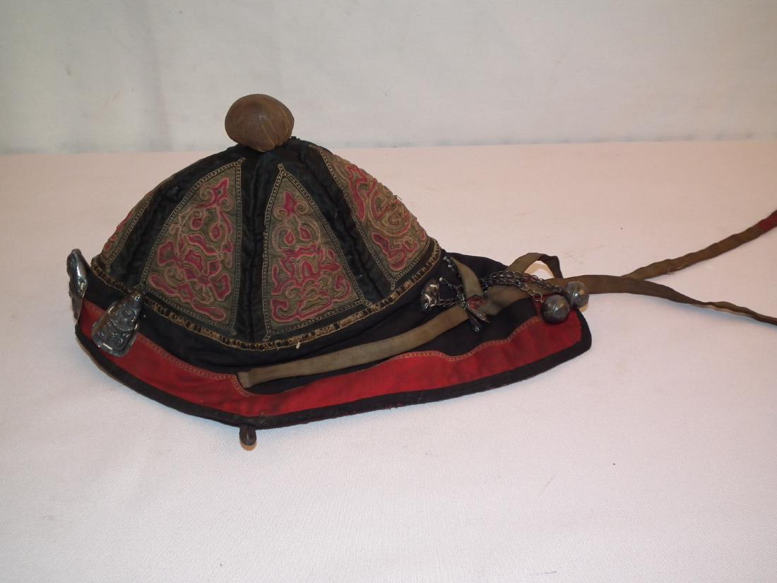 MONGOLIAN HAT: Antique Mongolian embroidered hat with silver embellishments. 12 inches long.