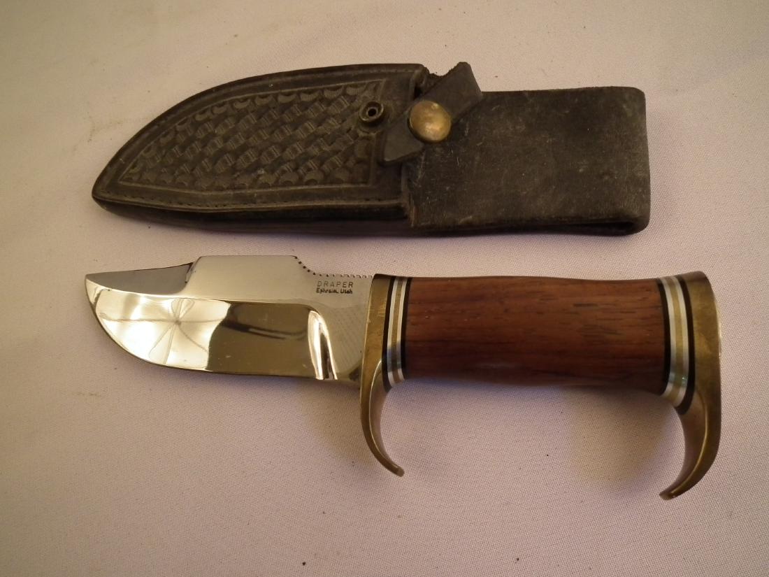 H. DRAPER BOWIE KNIFE - KEITH: Fine vintage Elmer Keith design, heavy clip point hunting knife with curved hand guard, brass and wood handle signed Draper, Ephraim Utah with black leather sheath. 9 inches long, blade 5 inches.