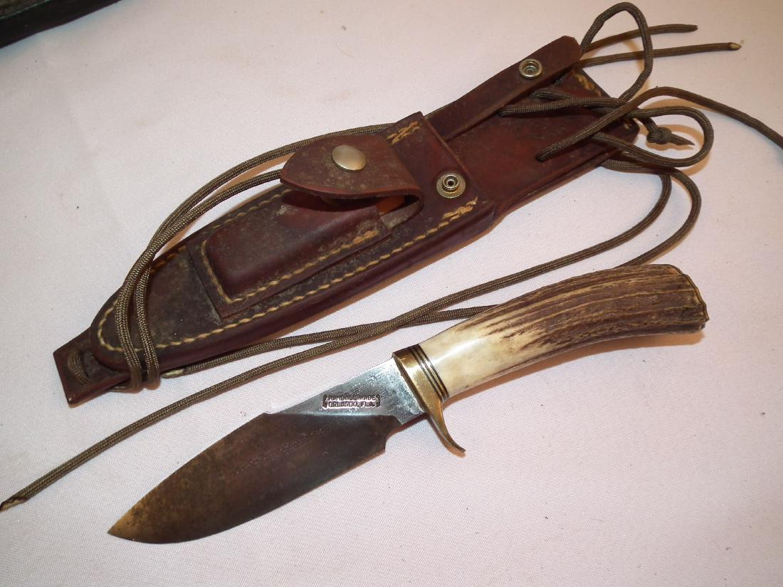 RANDALL MADE KNIFE: Randall Made of Orlando Florida stag, wood and brass handled knife (cross angled blade) with dark brown sheath. 9.5 inches, blade 5 inches.