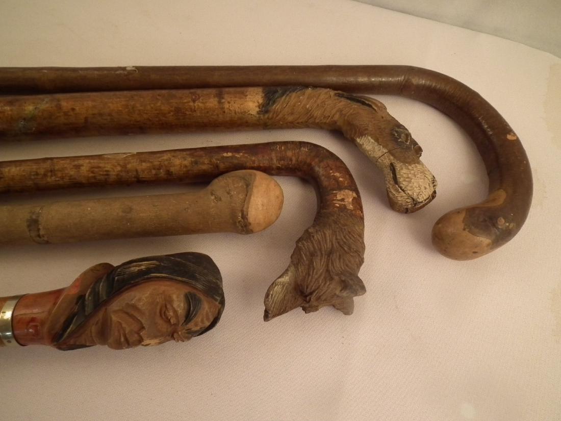 5 ASSORTED CANES: Lot 5 assorted carved wood canes including 1921 Indian head with carved names on shaft; double dog head; fox head; 2 plain. To 36.5 inches long.