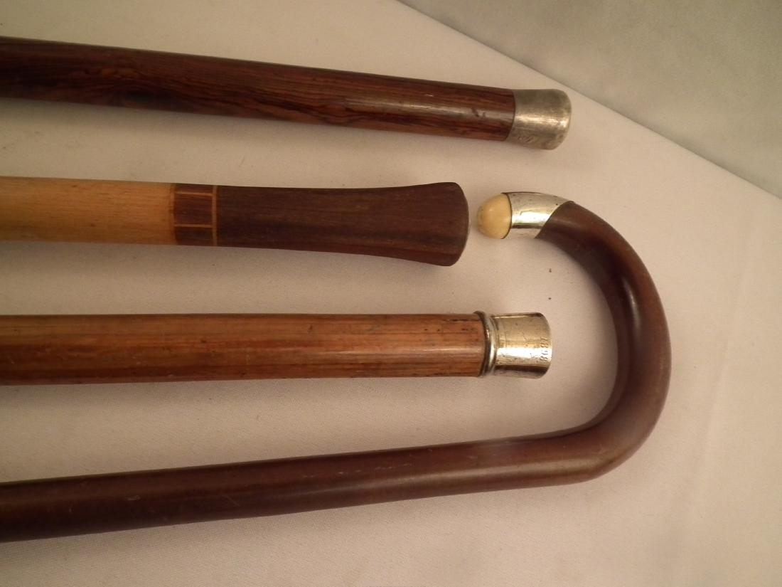 4 SILVER CANES: Lot 4 old canes with silver including: Silver tipped dated 1848-1898; silver knob with rosewood shaft; silver tip with inlaid wood stamped CPC/WMC 1924; and silver, bone, and wood curved handled cane.