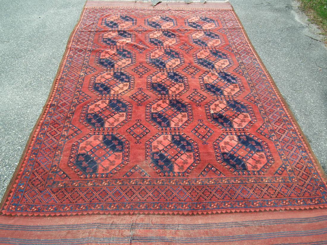 OLD AFGHAN RUG: Semi-antique Afghan room size rug in red and blue with octagonal boxes, 11 ft 6 x 7 ft 4 inches. Some tears on flat end panels.