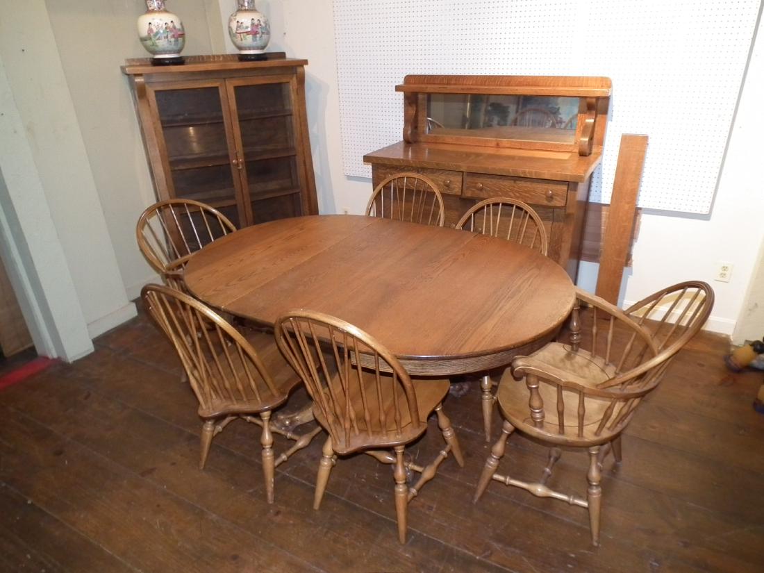 OAK DINING SET: Victorian oak dining set consisting of a mirrored sideboard; china cabinet; round claw foot table; and 6 maple windsor chairs signed Nichols and Stone. Plus 2 leaves. Table is 42 in diam., sideboard i