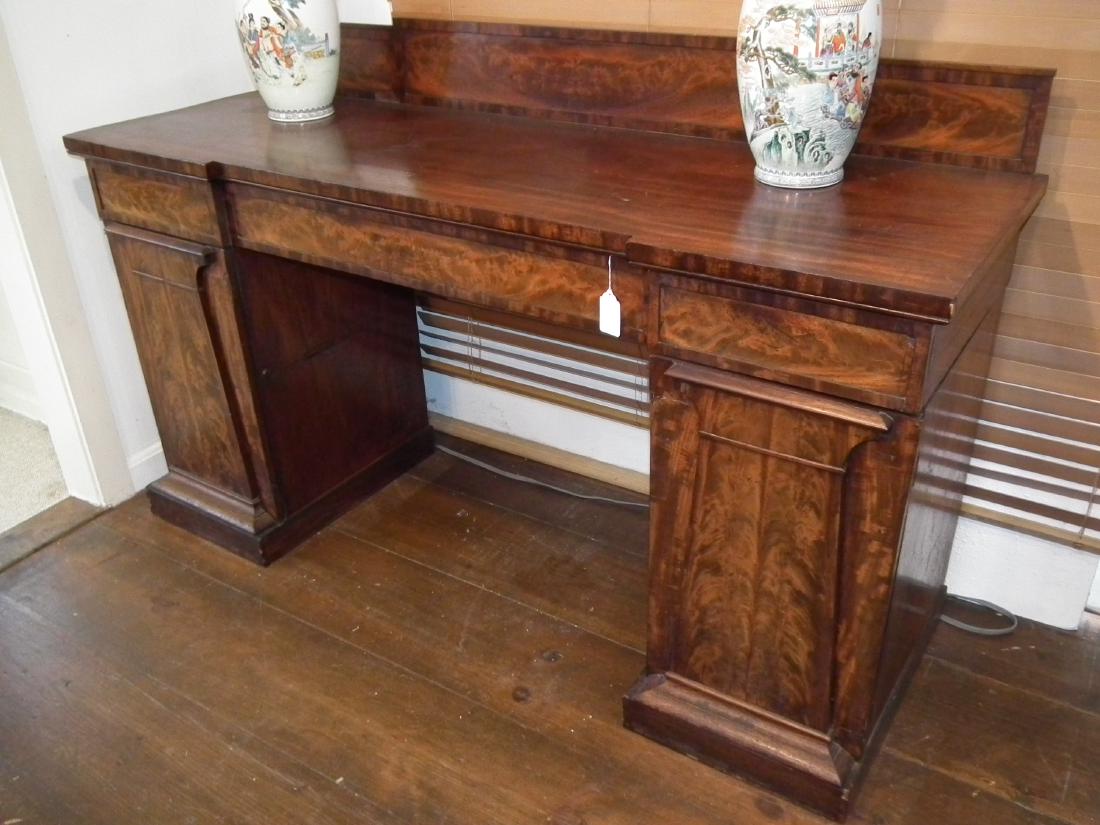 ANTIQUE MAHOGANY DOUBLE PEDESTAL SIDEBOARD: 19th century classical style double pedestal sideboard with gallery, crotch mahogany veneer, 6 feet long x 24 deep x 44 high. Doored compartment on each end.