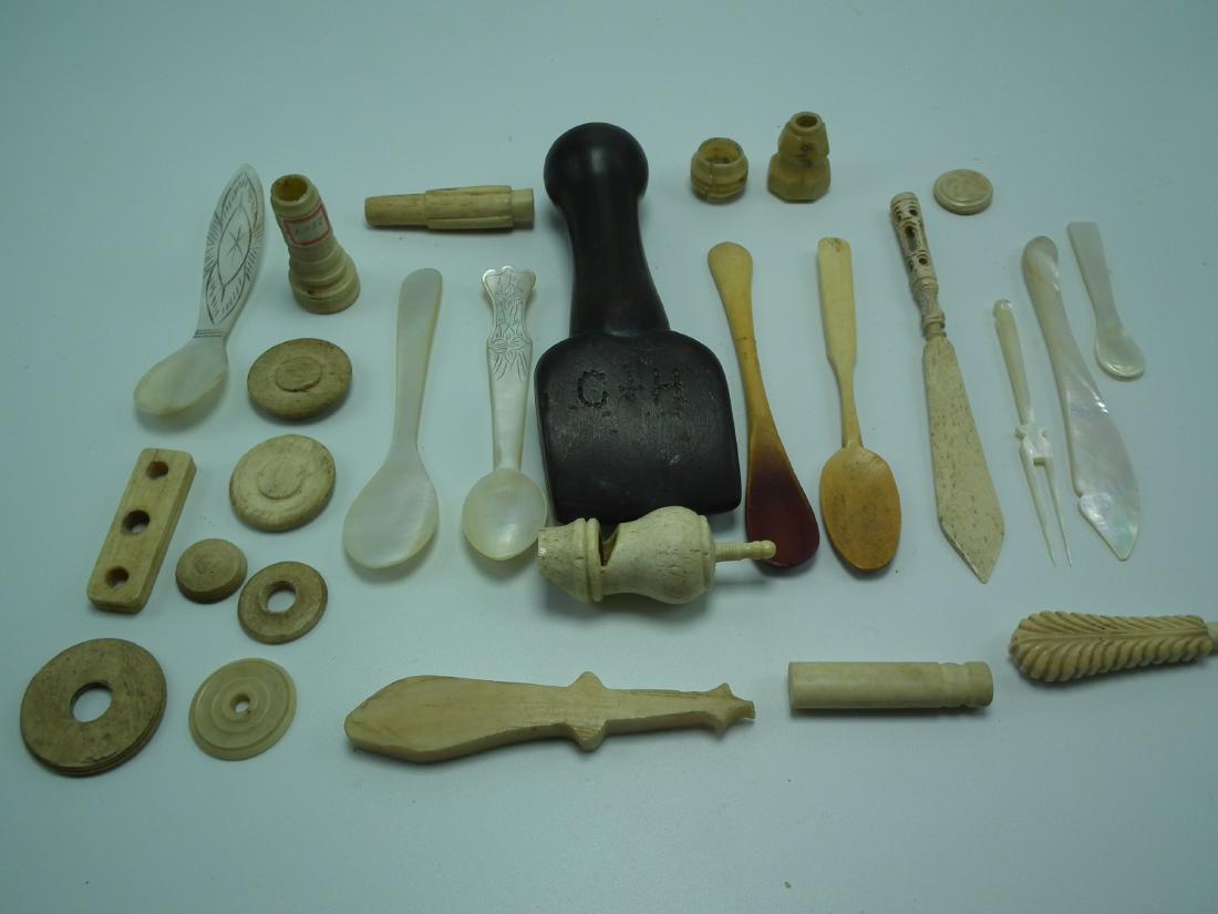 SAILOR MADE ITEMS: About 25 pieces of assorted carved sailor-made pieces including: 5.5 inch wood seamer sgd CH; whistle; spoons; and other implements & whimsies. Most bone, some abalone.
