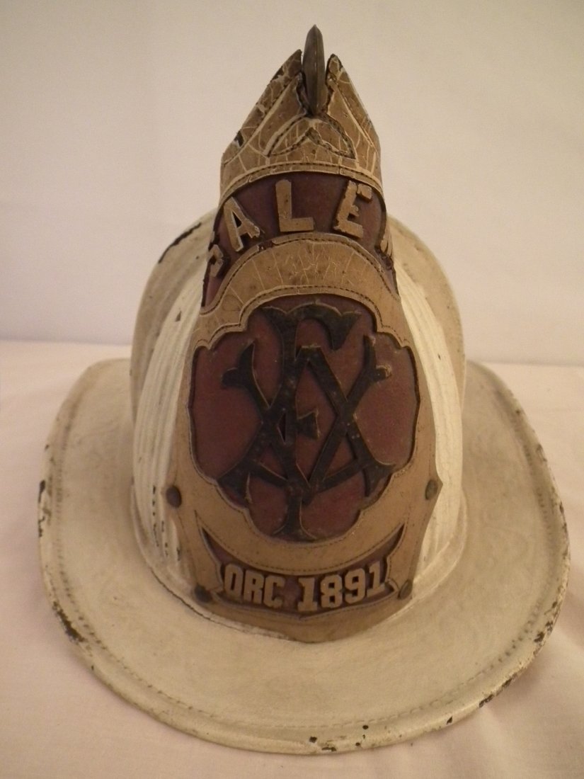 1891 SALEM FIRE HELMET: Antique leather fire helmet signed Dolfini (rare maker) with leather badge - SALEM ORG. 1891. Brass eagle holder. 15 in long and 9 in high.