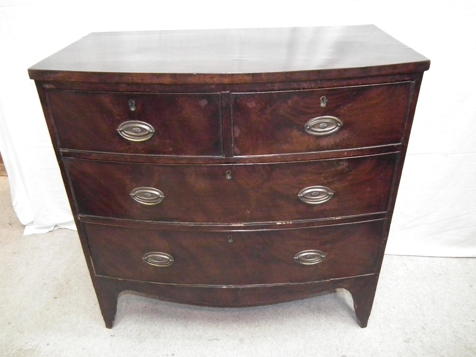 18TH C. HEPPLEWHITE CHEST: 18th century Hepplewhite bow front 2 over 2 chest of drawers and oval brasses. 36 in long x 35 x 19 in deep.