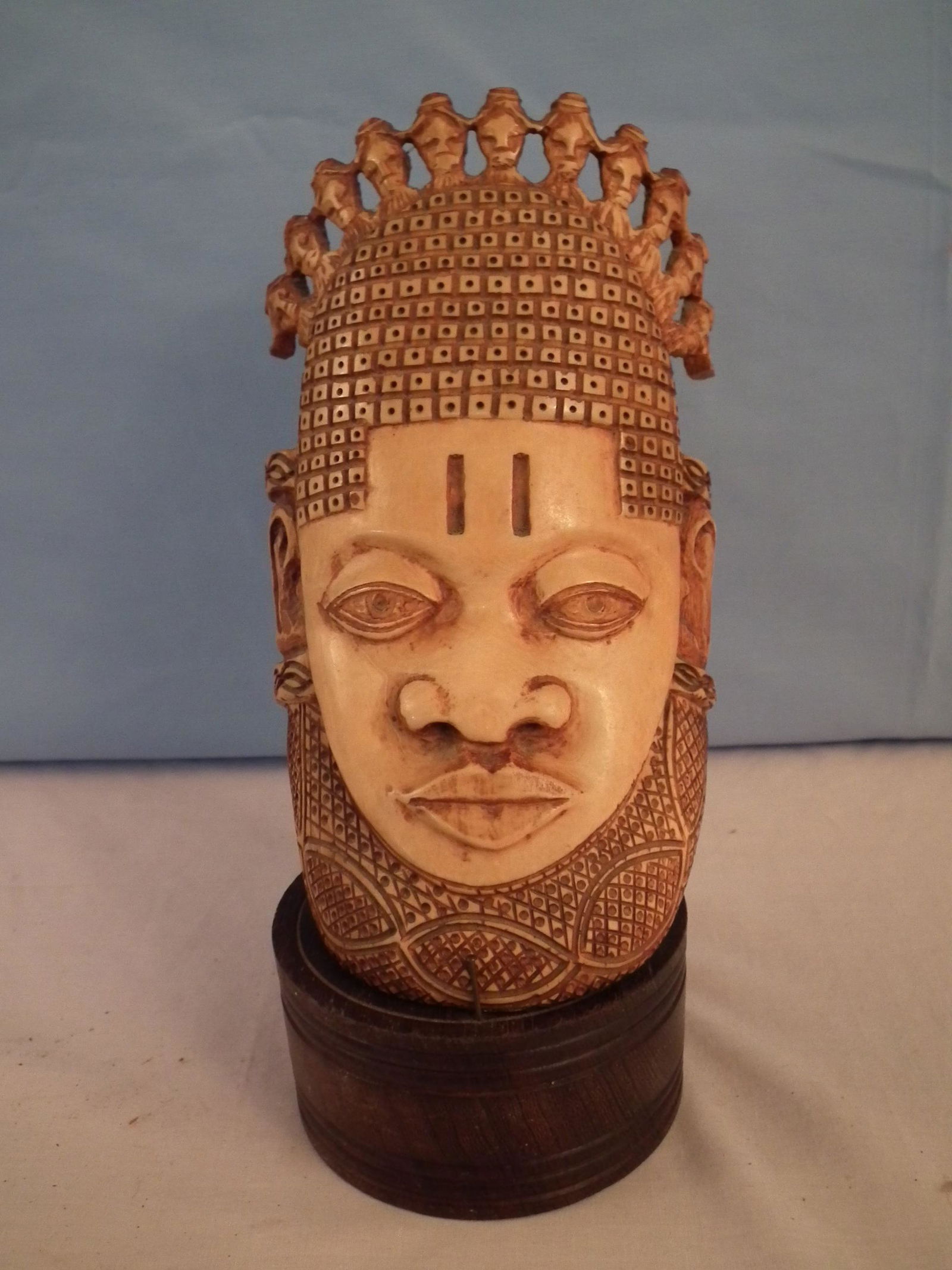 AFRICAN BONE MASK: Finely carved old African bone mask on wood stand. Mask is 8.5 in high, has one tight 2 inch crack at bottom.