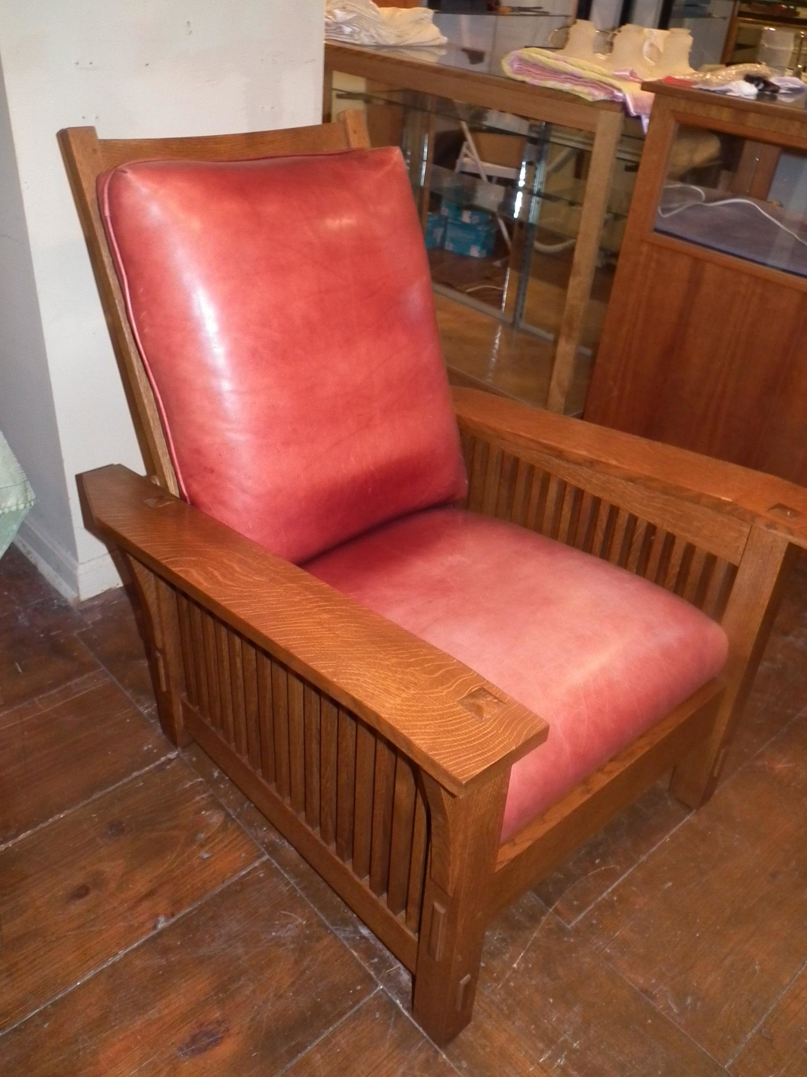 STICKLEY MORRIS CHAIR: Modern Stickley solid oak Morris chair with matching footstool, both signed Stickley. Chair has 2 leather cushions and 16 spindles on each side. 39 high x 33 w x 37.5 d. Footstool dated 1991 is 14 x 1