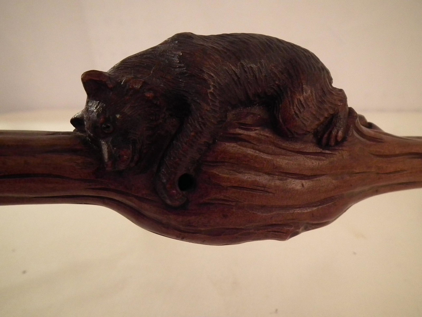 BLACK FOREST BEAR CANE: Antique 36 inch long carved walnut Black Forest cane with reclining bear music box (works missing).