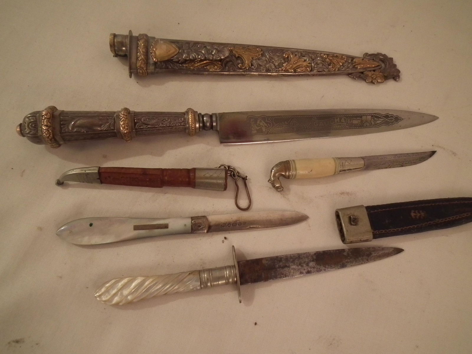 4 OLD KNIVES: Lot assorted vintage and old knives: 10.25 inch fancy GAUCHA knife; 7 inch small knife with abalone inlay; 4.5 inch knife with horse head; and 5.5 inch English hallmarked knife with abalone inlay.