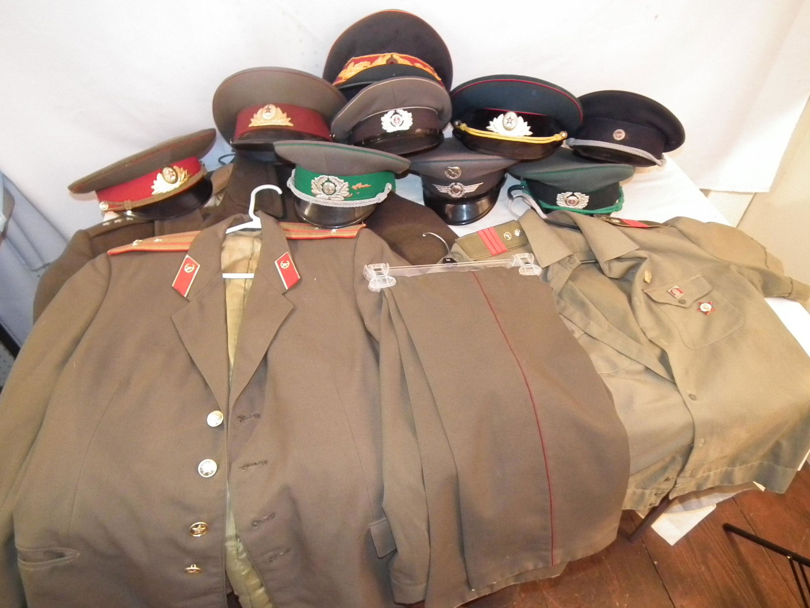 OLD POLISH UNIFORMS ETC: Lot of mostly post-war Polish uniforms and hats including jacket, coat, shirt, and pants.