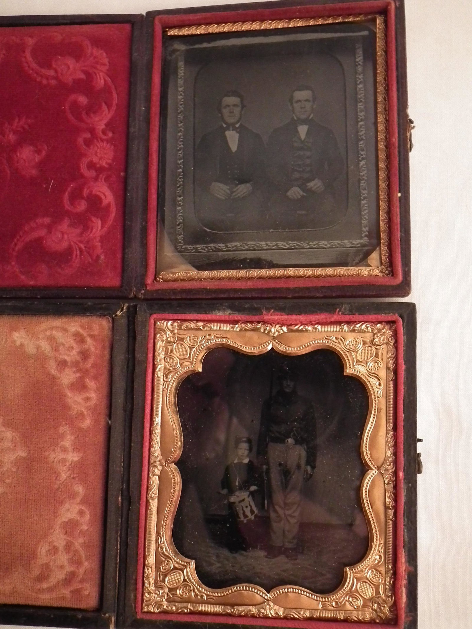 2 CIVIL WAR AMBROTYPES - SOLDIER & DRUMMER: Lot of 2 Civil War era cased ambrotypes: One of Union? soldier holding rifle and large bowie knife with young Zouave drummer boy beside him, 3.12 x 2.75 inches; and one of 2 gentlemen, 3 x 2.62 inches