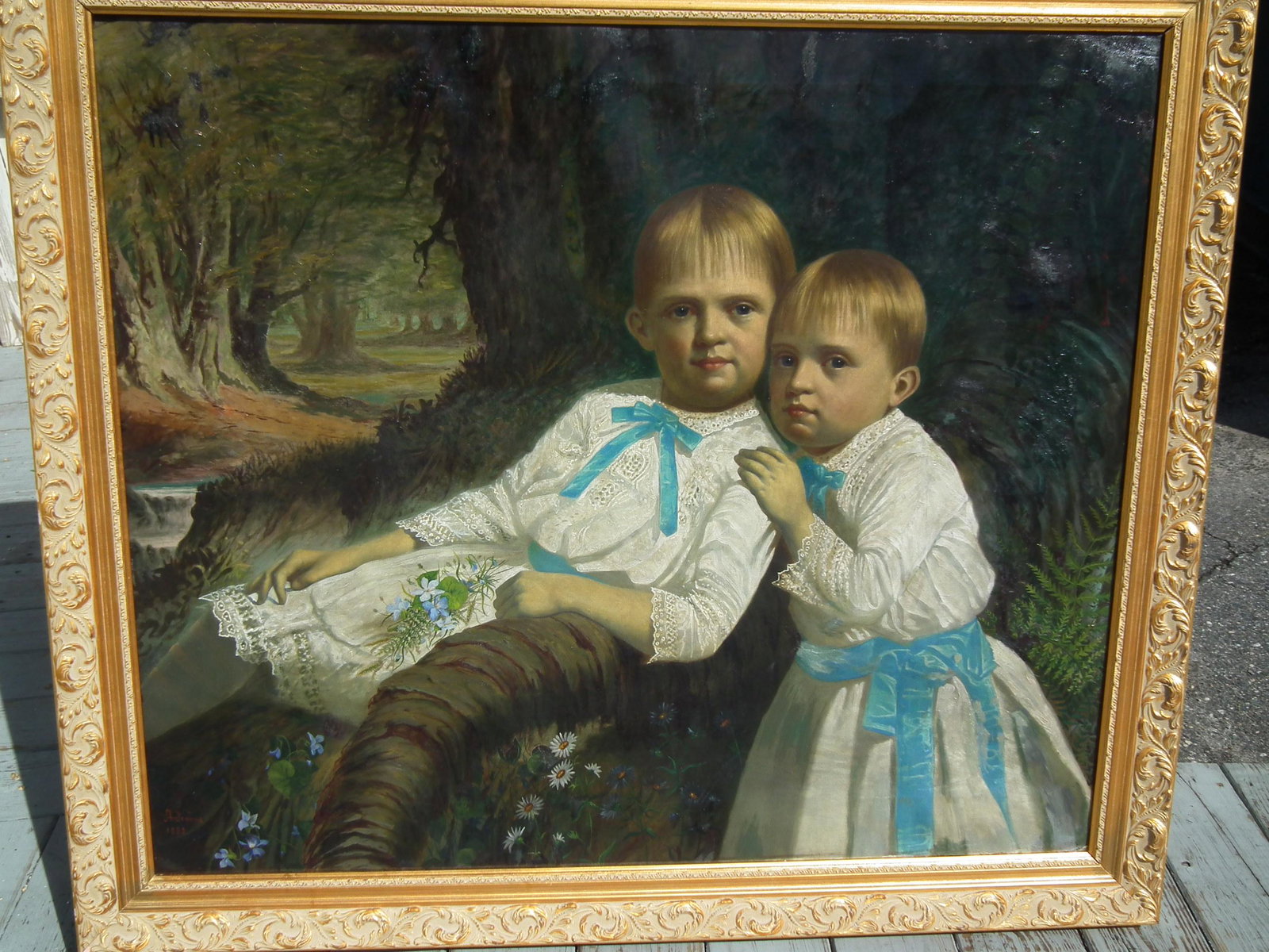 JOHN ANTROBUS PAINTING OF CHILDREN: 19th century oil portrait of 2 young blond children in a southern wooded landscape signed John Antrobus in lower left. Size: 36 x 42 inches. (John Antrobus 1837-1907 was an itinerant painter from Geor
