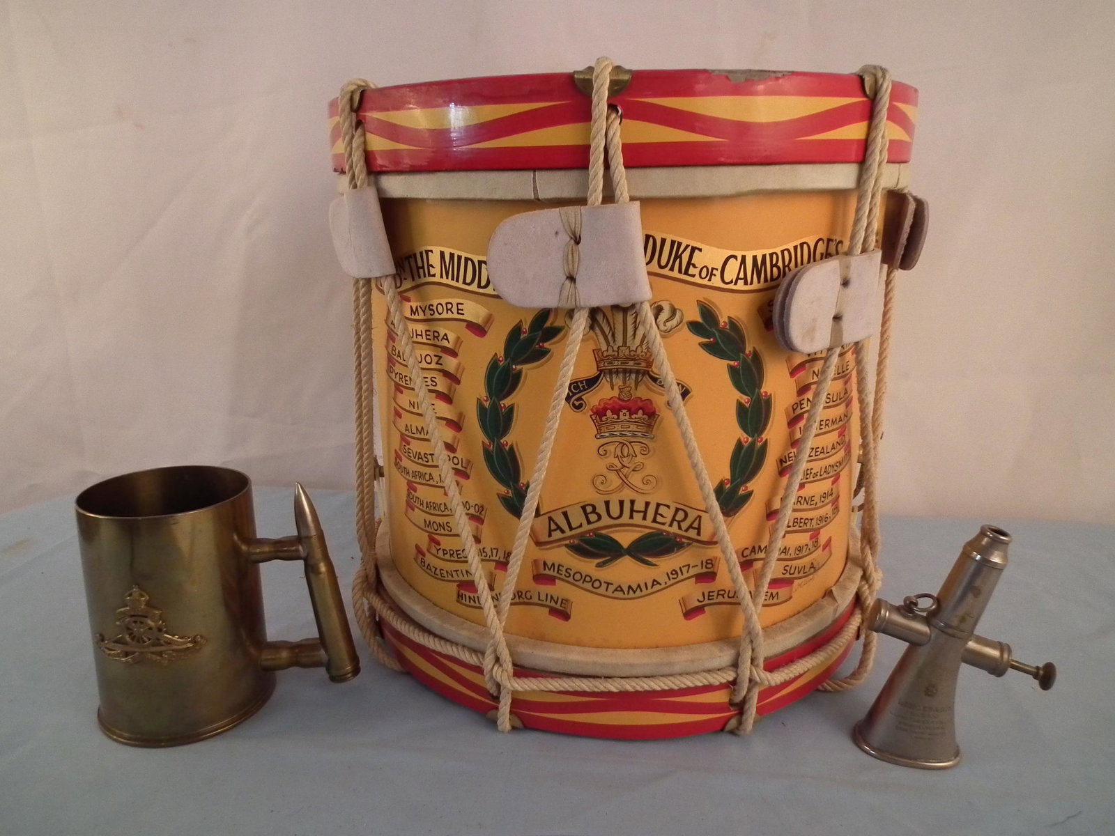 ENGLISH DRUM MILITARY LOT: Lot of 3 English military items: 14 inch Engish wars commemorative painted drum; Koher & Sons London regimental horn; and Royal Corps Army Ordnance mug made from a brass artillery shell, London, 5.5 i
