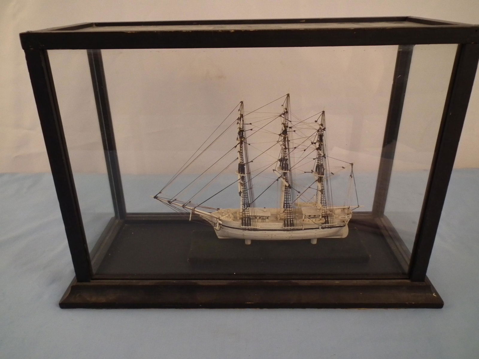 BONE SHIP MODEL BY SAYLES: Fine old whale bone 3 masted ship model of THE SWORDFISH in glass case attributed to Charles Sayles (Nantucket master craftsman, died 1994 at age 85). Model is 9 x 8 inches, case is 16 x 11 x 7.