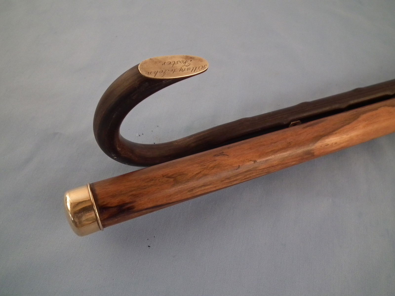 2 ANTIQUE CANES: Lot of 2 canes, both 35.5 in long: shepherd's hook type with gold oval HILLARY TO JOHN FOSTER, gnarly rosewood shaft; and rosewood shaft with gold cap (not marked, probably solid gold).