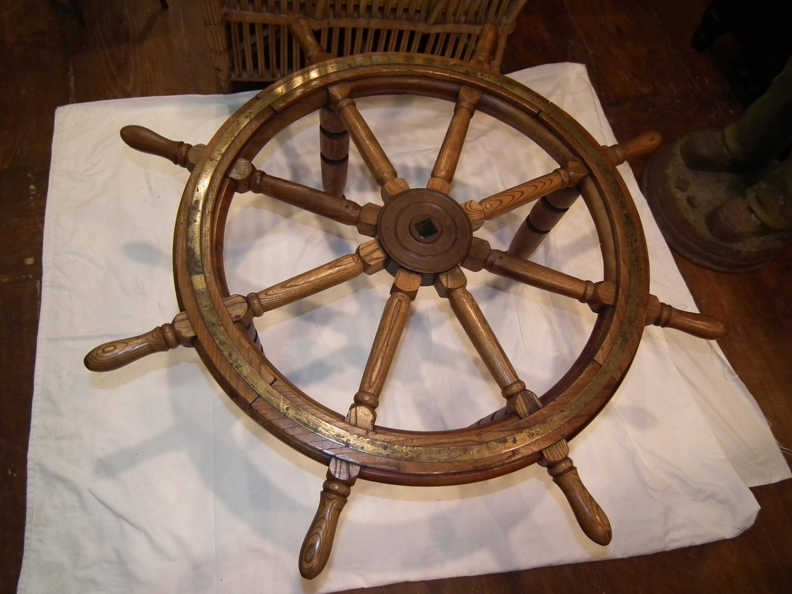 SHIPS WHEEL COFFEE TABLE: Old ship's wheel coffee table (no glass) in wood with brass trim. 40 in diameter (28 for glass) x 17 in high.
