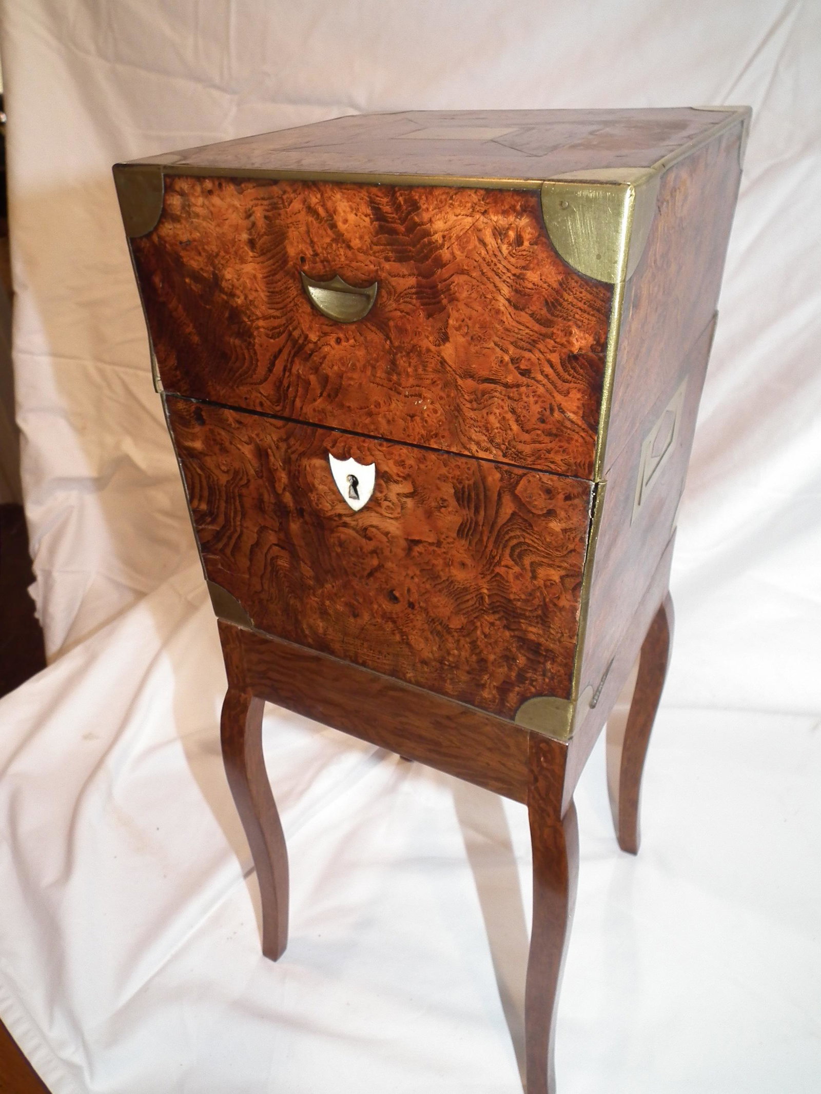 BURL WALNUT CAMPAIGN CELLARETTE: 19th century burl walnut cellarette box with leather interior for decanters, mounted on later stand. 8 x 8 x 22 in high.