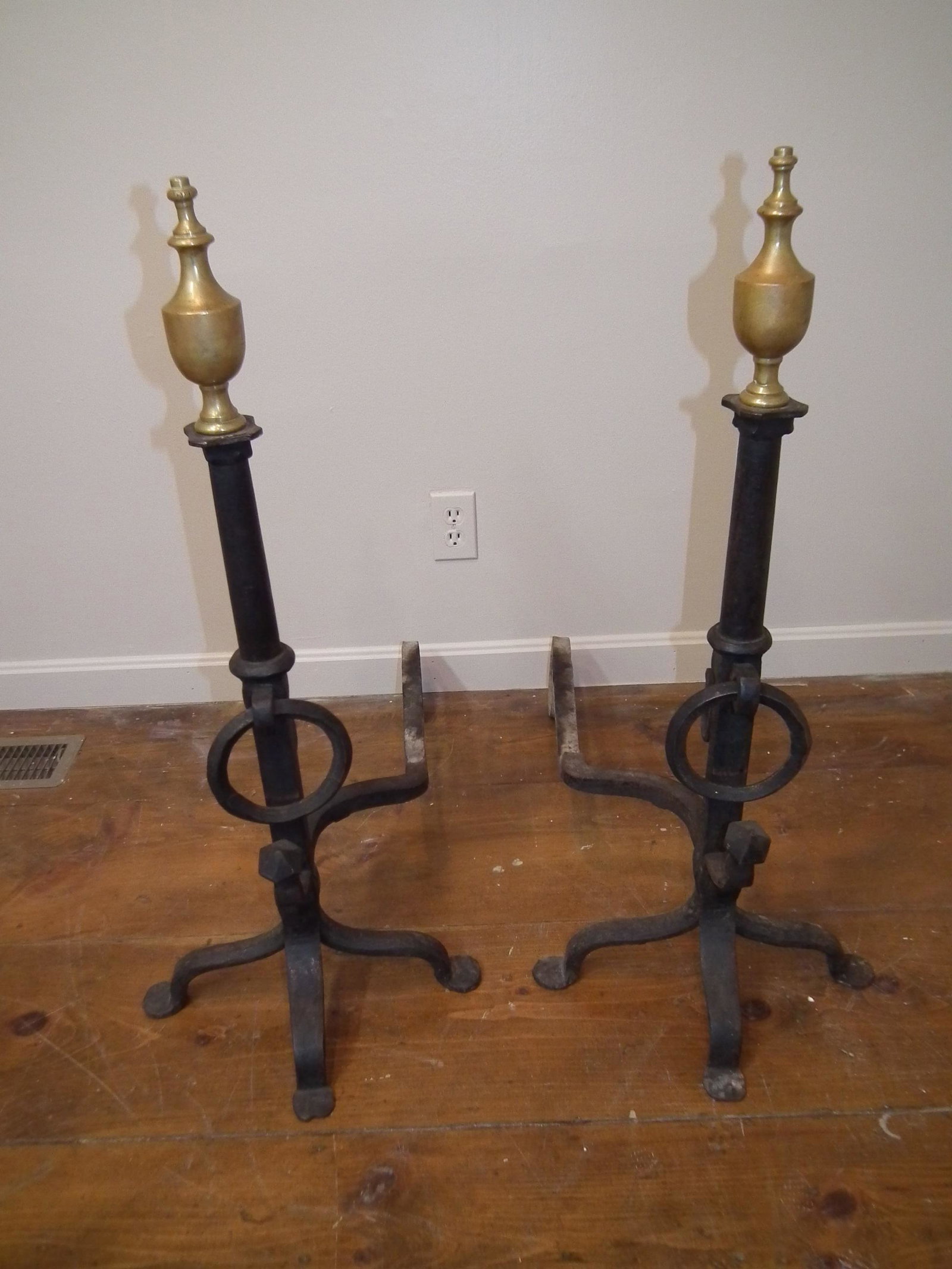 PAIR LARGE A&C ANDIRONS: Pair antique hammered iron and brass Arts and Crafts period tall andirons with urn tops, penny feet and large rings. 36 in high and 30 in deep.