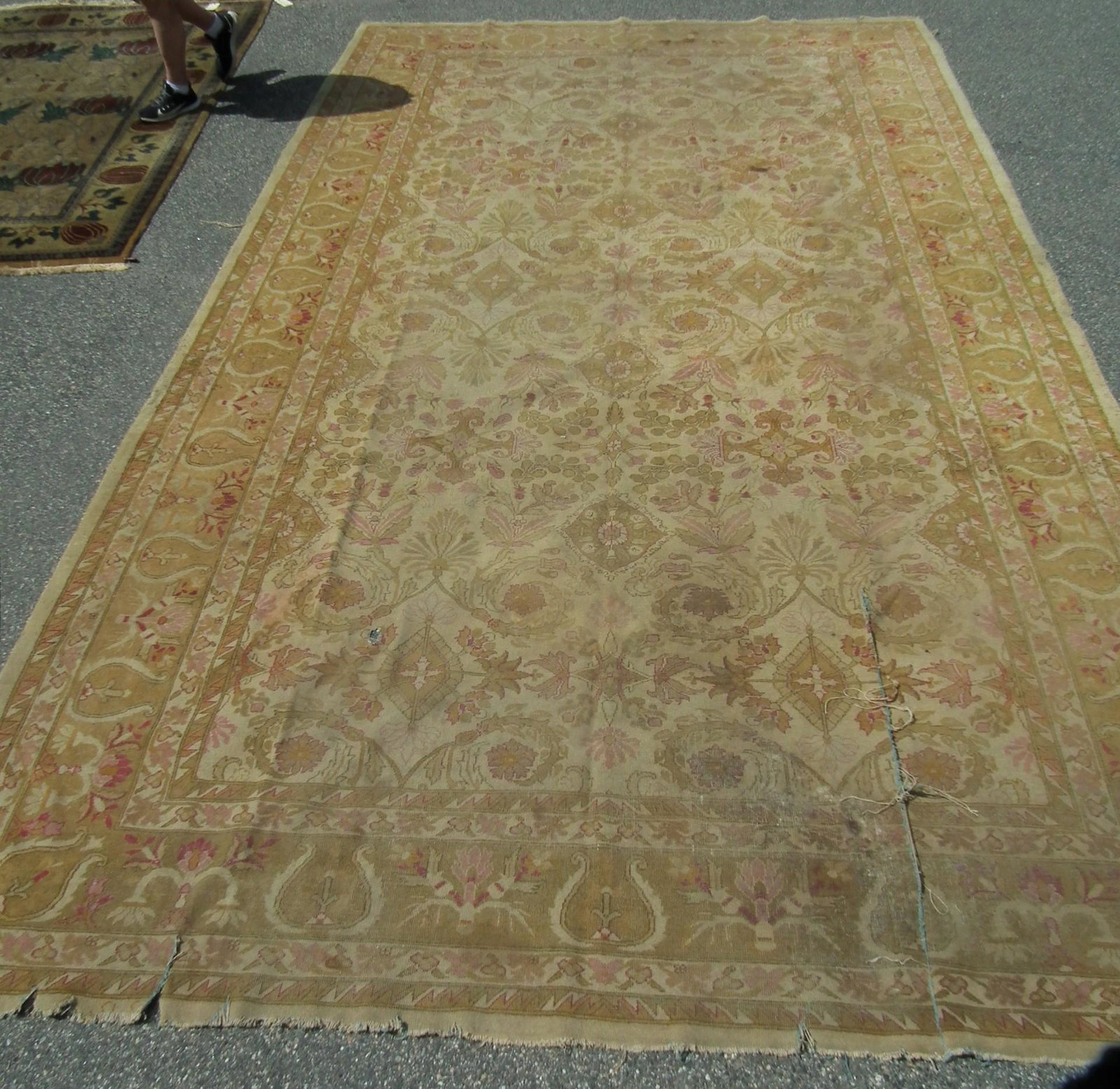 ANTIQUE AGRA CARPET: Antique Agra room size carpet approx. 10 ft x 17 ft 7 inches. Sold as is needing restoration (tears, scattered stains & wear).