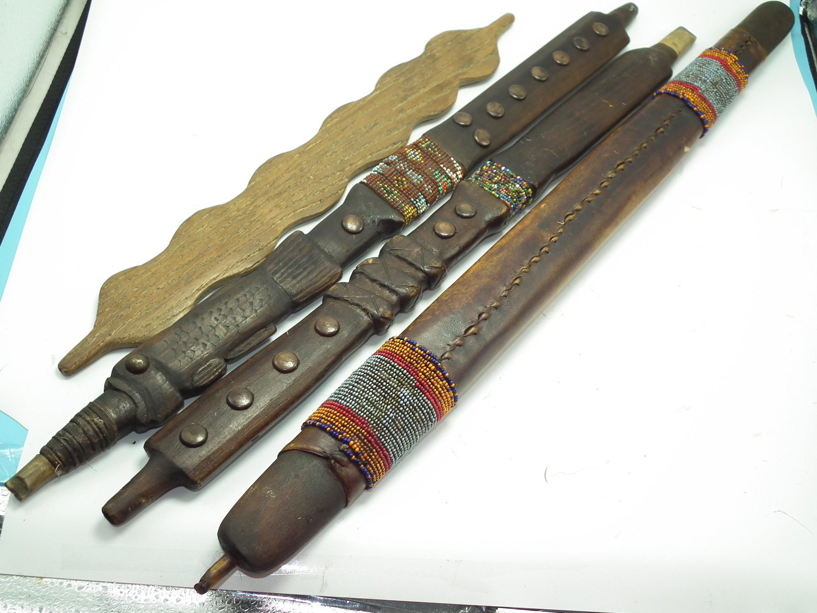 4 INDIAN PIPE STEMS: Lot 4 Native American wood pipe stems - one with painted snake on vellum? and beads; carved fish with beads; snake wrap carving with beads; and wavy oak design.