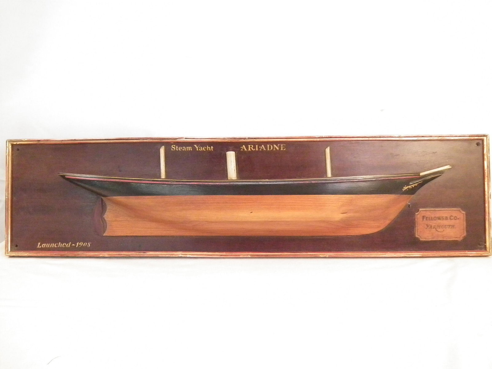ARIADNE HALF HULL MODEL: Vintage wood wall half hull ship model of the Ariadne by Fellows & Co, Yarmouth, Launched 1908. 40.5 in long x 10 in high.