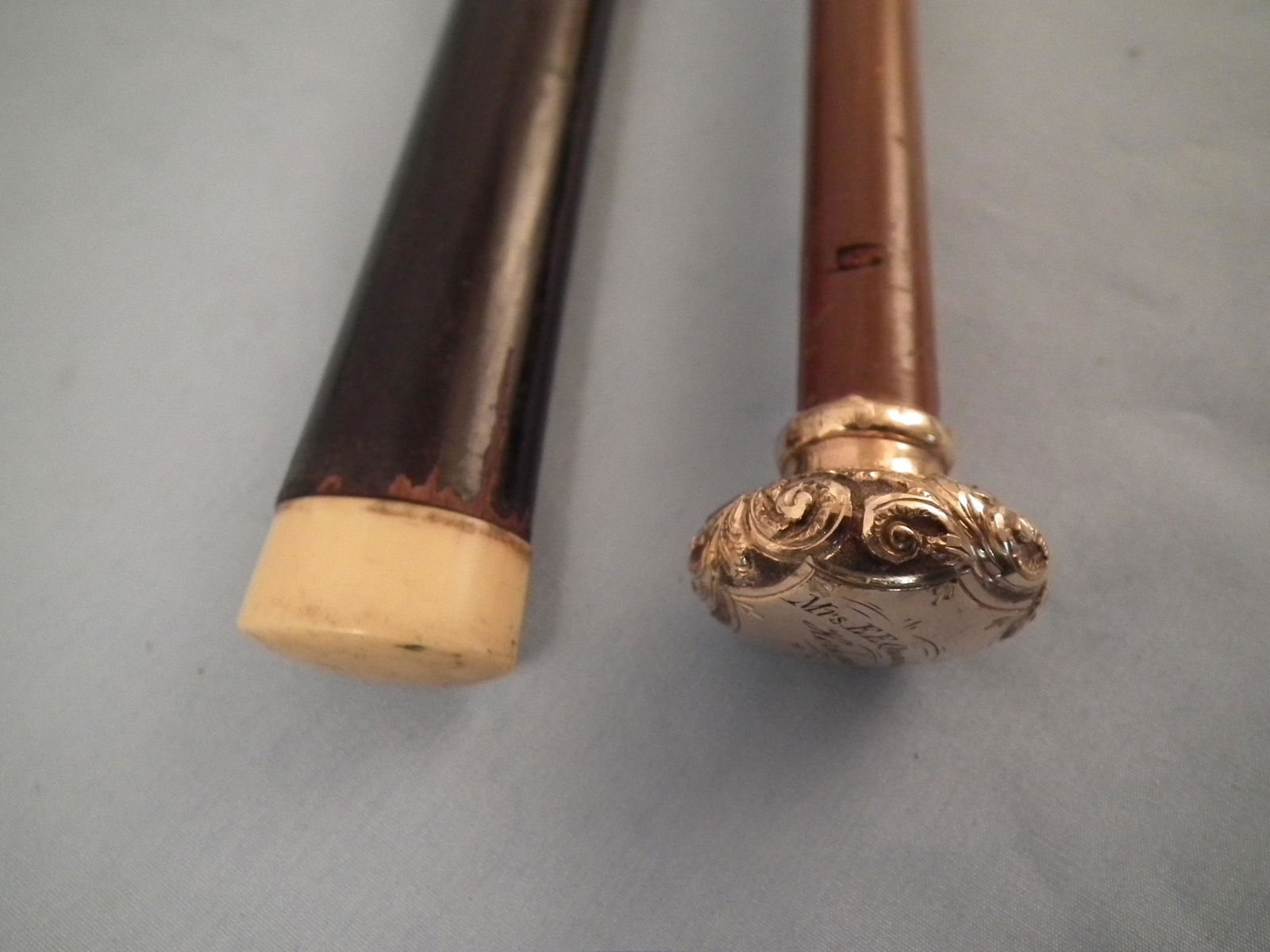 2 ANTIQUE CANES: Lot of 2 antique canes: fancy gold filled knob with owner name MRS. QUACKENBURSH, HERKIMER NY, 30 in long; and a ebony shaft with small bone cap, 36 in long.