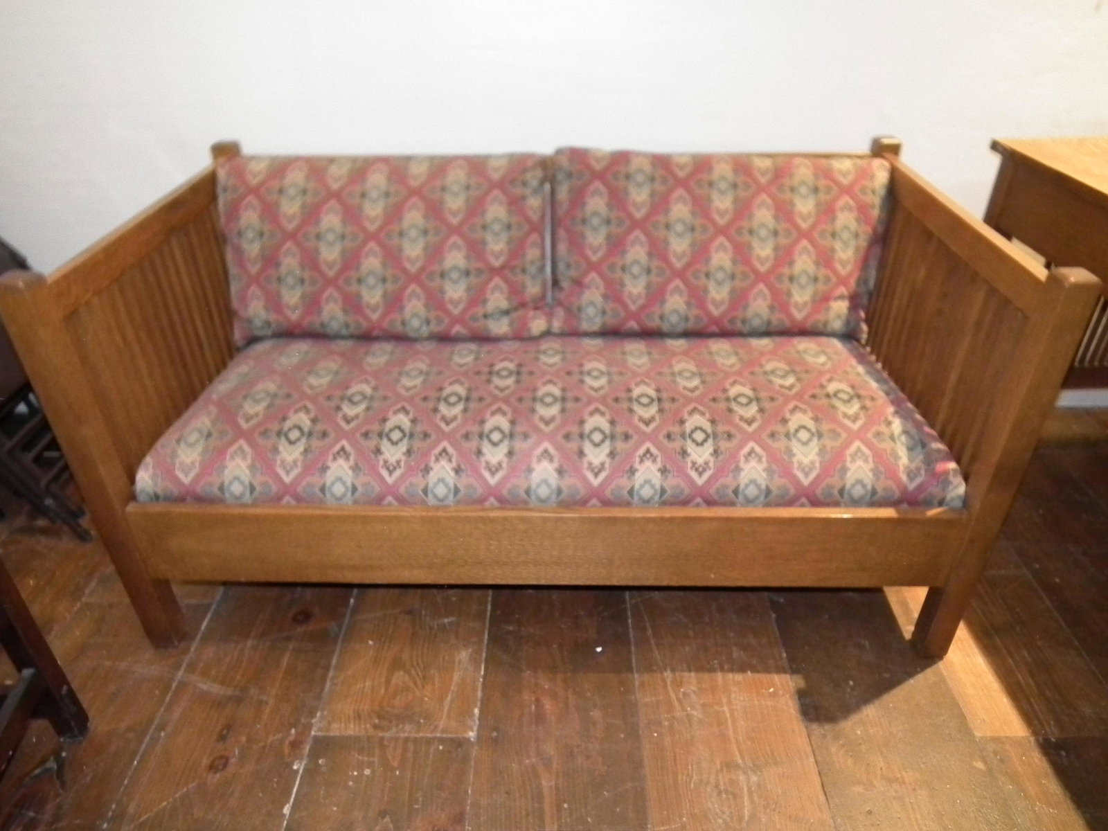 STICKLEY OAK PRAIRIE SETTLE: Vintage golden oak Stickley Prairie spindle settle with upholstered cushions, has Stickley metal label on underside. 60 inches long x 32 deep by 30.5 in high. Seat is 16 inches high.