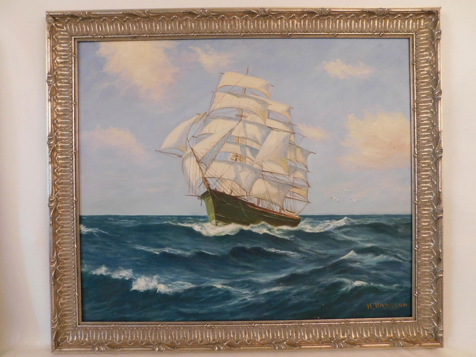 H. HANSSON PAINTING OF CLIPPER SHIP: 20th century oil painting on masonite of a clipper ship signed H. Hansson. 19 x 23, framed 23 x 26 inches.