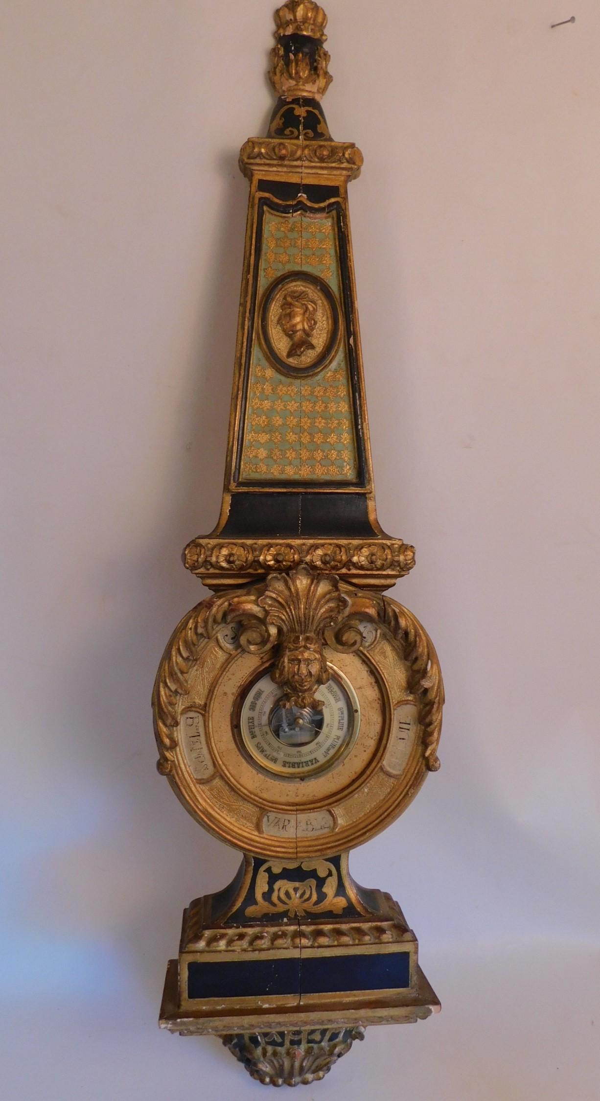 FRENCH GILT BAROMETER: Old gilt wood fancy French wall barometer with carved heads. 40 in tall x 10 wide. Working.