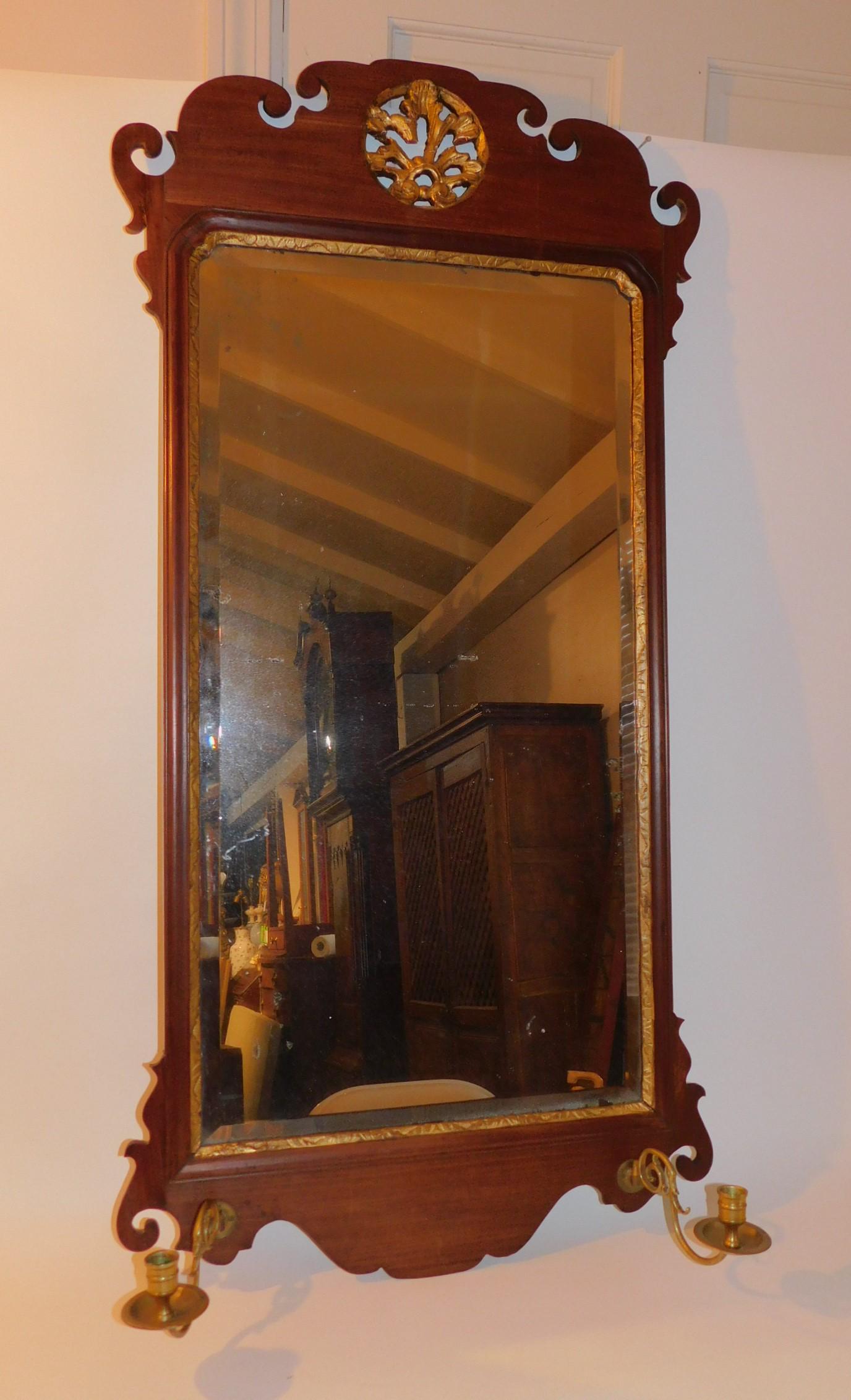 18TH C. AMERICAN CHIPPENDALE MIRROR: Fine AMERICAN Chippendale 18th century wall mirror with upper circular gilt gesso reticulated medallion and brass candlestick holders. Upper ears replaced, otherwise appears all original. 48 in tall x