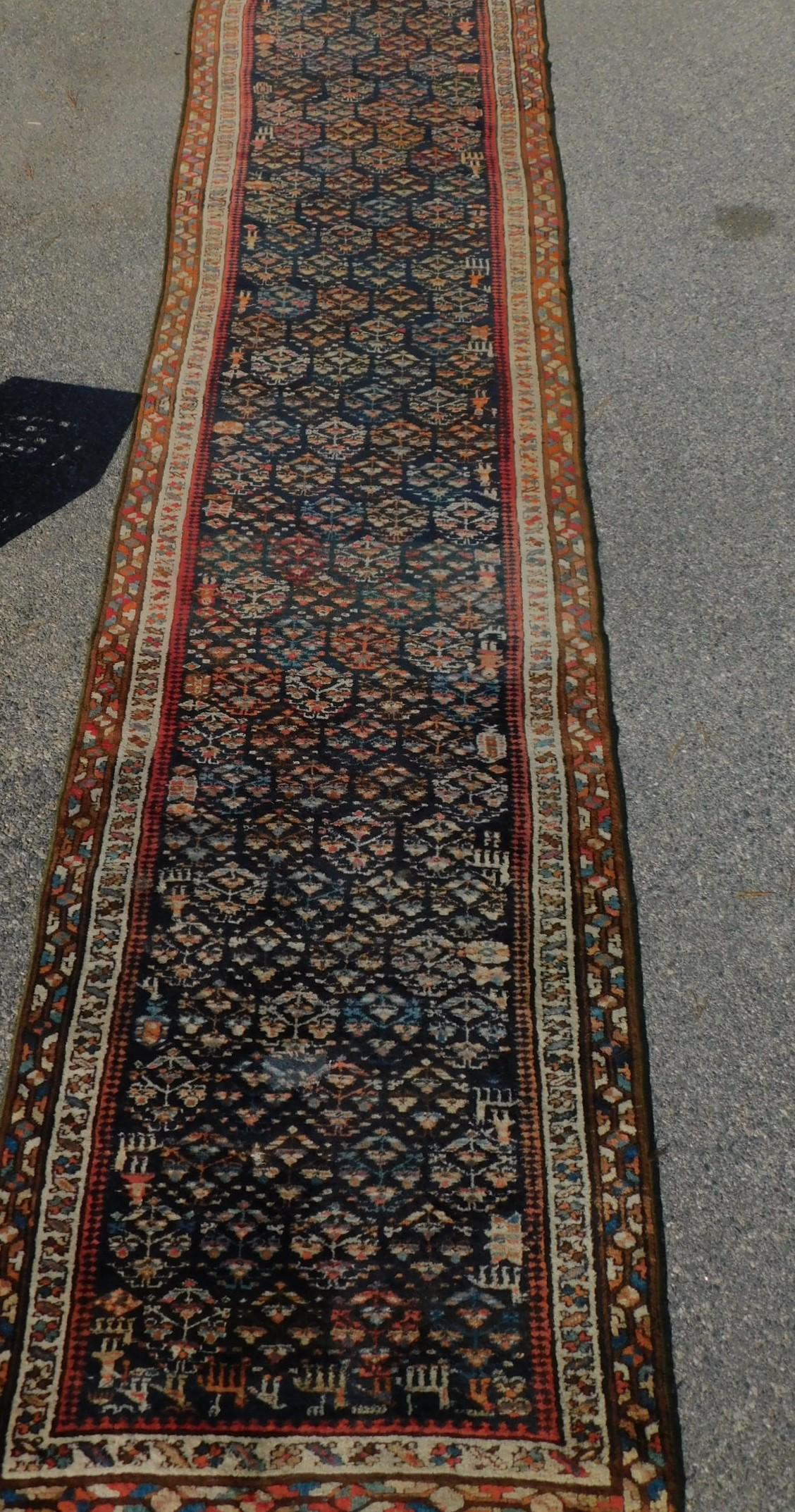 ANTIQUE NW PERSIAN 16 FT RUNNER: Antique Northwest Persian hall runner carpet with animals, figures, etc on navy blue field. 3 ft 4 x 16 ft 7 inches. VG condition, small patch.
