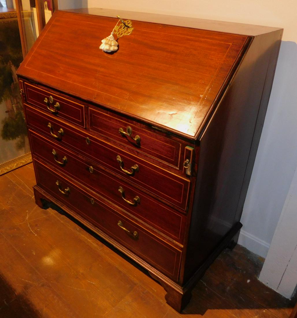 ANTIQUE ENGLISH GEO. III INLAID DESK: Period English George III mahogany slant lid desk, bracket feet with fitted interior and line inlay. 40 in wide x 20 x 42 high. Repair to small section lower back side.