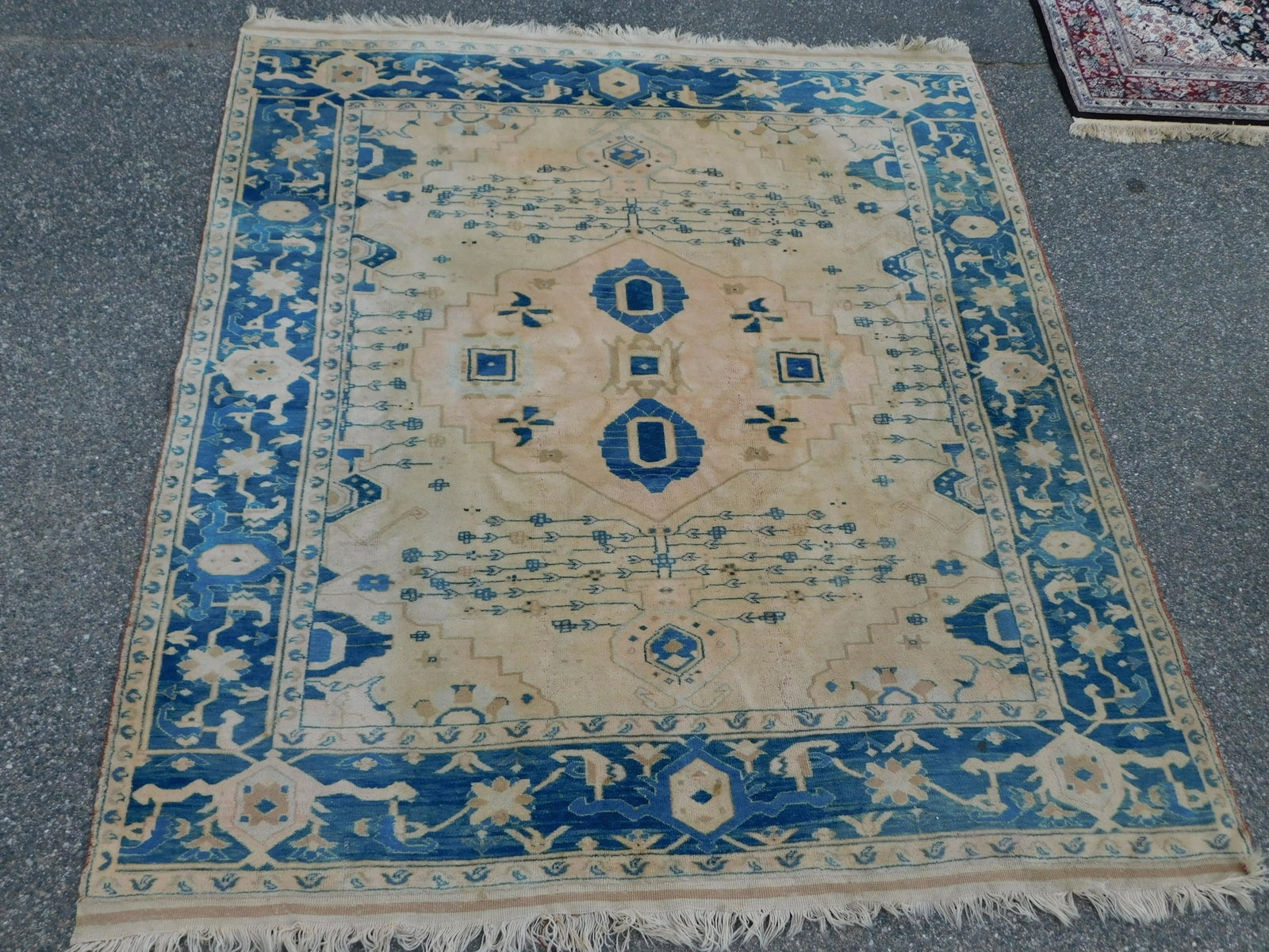 ANTIQUE TURKISH CARPET: Antique blue and white Turkish room size carpet, good condition but faded. Size: 7 ft 8 inches x 8 ft 8 inches.