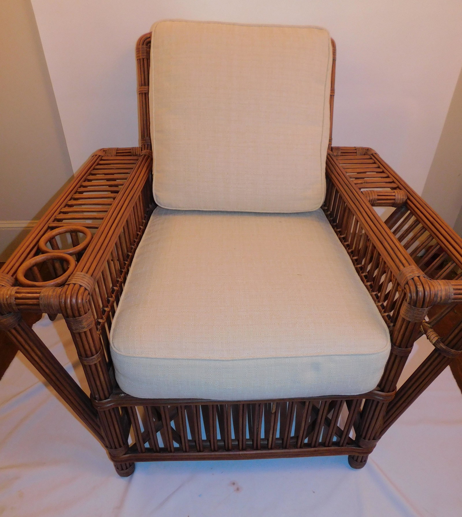 PALECEK RATTAN A&C CHAIR & OTTOMAN: Vintage pole rattan Arts and Crafts occasional chair with drink holder and magazine stand (31 x 40 w x 36 in high) with clean upholstered cushions signed PALECEK (San Francisco). Comes with matching o