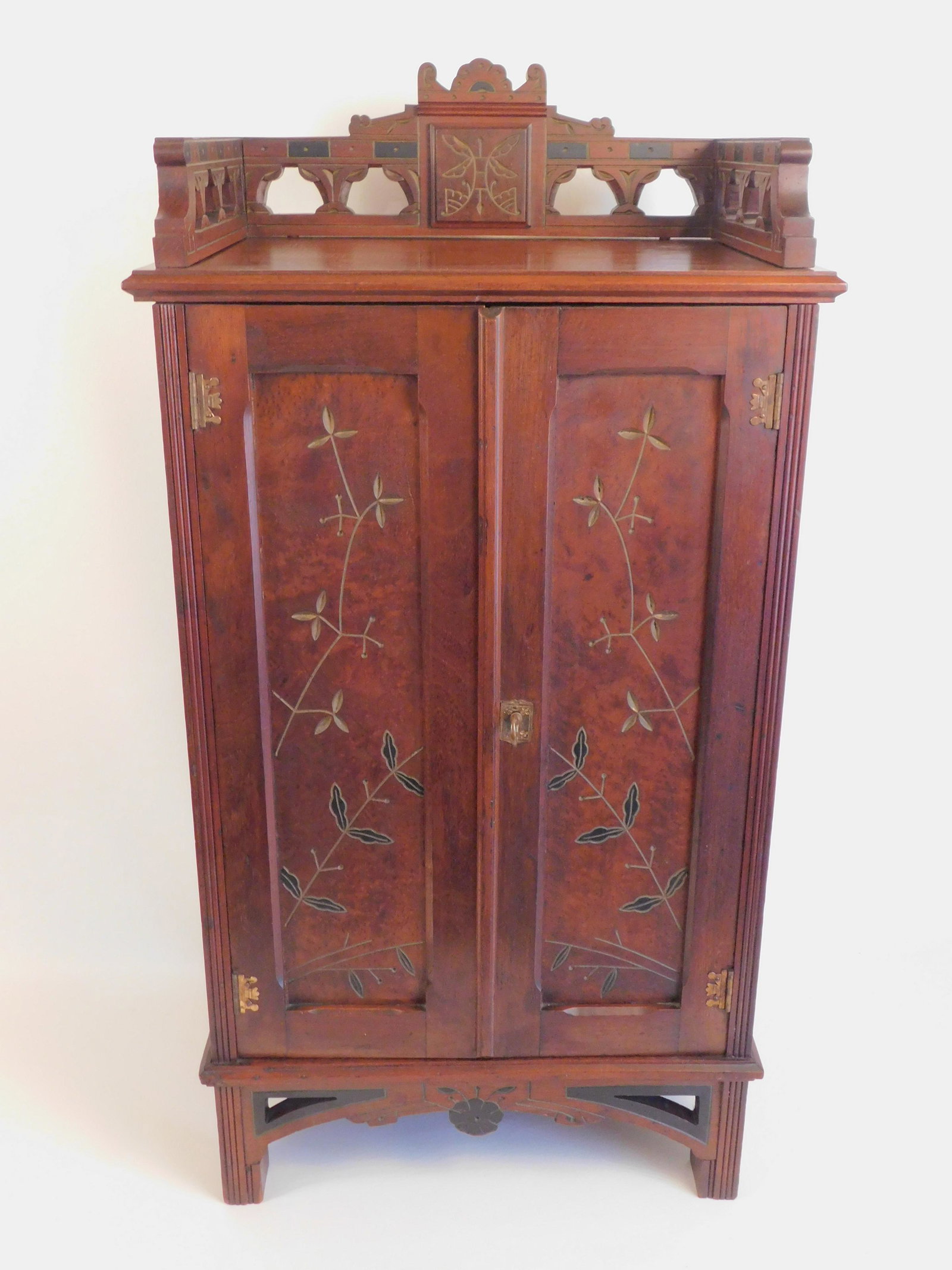 VICTORIAN AESTHETIC MUSIC CABINET: Victorian Aesthetic movement 2 door walnut sheet music cabinet with incised floral designs and gallery (with key). Size: 36.5 in high x 18 x 13 inches. Exc. Condition.