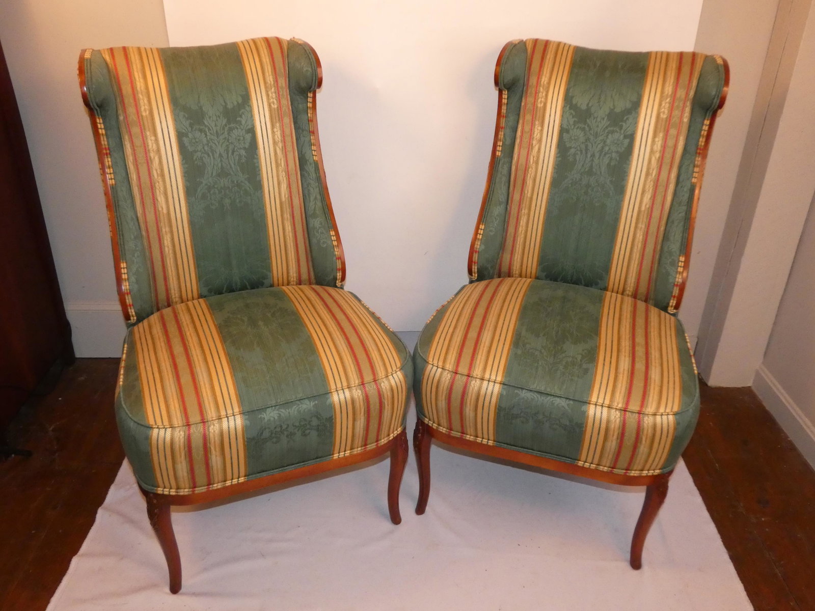 PAIR REGENCY STYLE CHAIRS: Fine pair of custom Regency style easy chairs with saber legs, striped upholstery and floral rosettes. 40 high x 24 x 20 deep. Excellent condition.