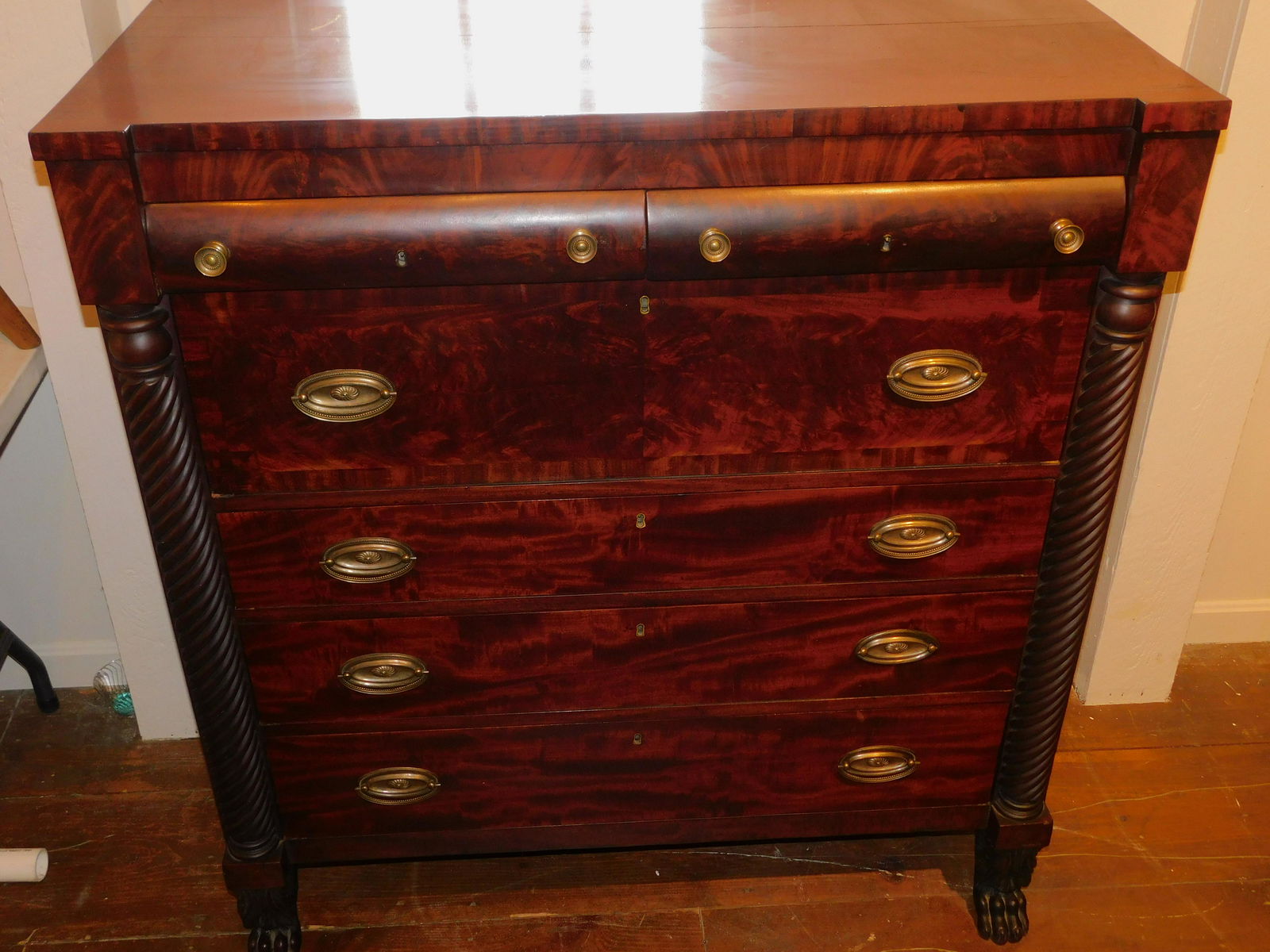 FEDERAL MAHOGANY CARVED CHEST: Antique American Federal/Empire period mahogany tall chest with rope twist half-columns, paw feet, and 2 convex upper drawers over 4 lower drawers. 48 in high x 44 wide x 21.5 deep. Appears all origin