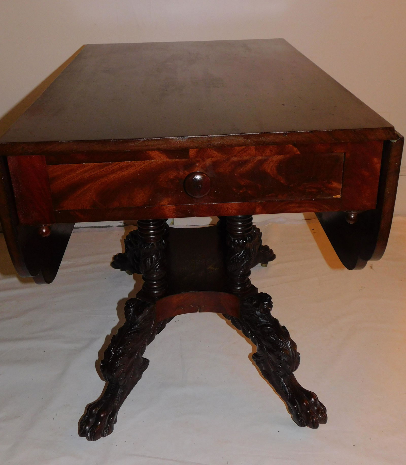 FEDERAL MAHOGANY DINE TABLE: Fine Federal period drop leaf mahogany dining table with heavily carved base with animal-form legs and paw feet. Size: 29 high x 39 deep x 23.5 wide (open 49 x 39 inches).