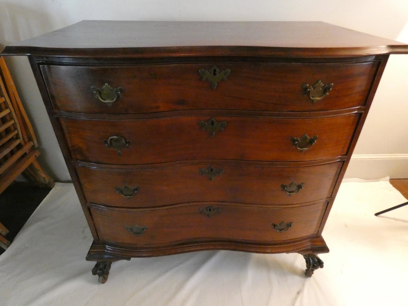 ANTIQUE CHIPPENDALE CHEST: Mid/late 19th century American Chippendale 4 drawer serpentine front chest with ball and claw feet (on casters). 38 high x 41 w x 23 deep.